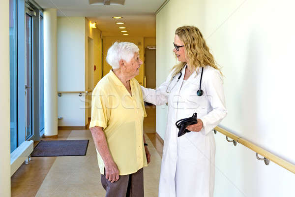Doctor Talking to Elderly at the Hospital Corridor Stock photo © belahoche