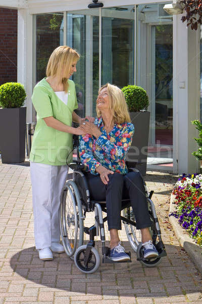 Nurse Showing Care for Senior Woman in Wheelchair Stock photo © belahoche