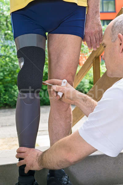 Therapist adjusting prosthetic leg Stock photo © belahoche