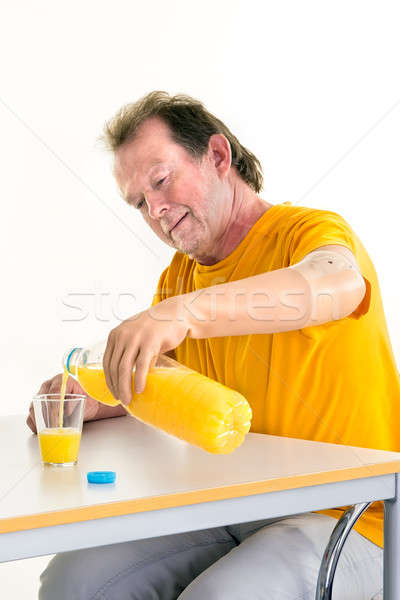 Middle-aged man using a bionic prosthetic hand Stock photo © belahoche