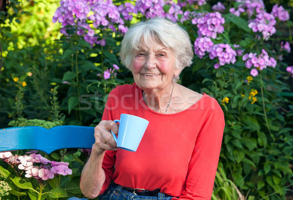 Happy Grandma Having a Coffee at the Garden Stock photo © belahoche