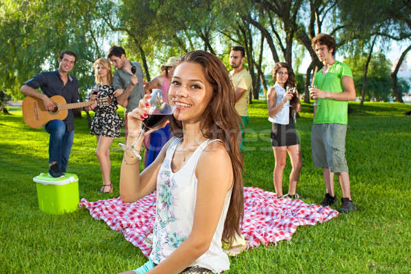 Happy young teenage girl sipping a glass of wine Stock photo © belahoche