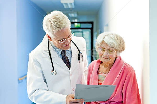 Doctor Shows Female Elderly Patient Results Stock photo © belahoche