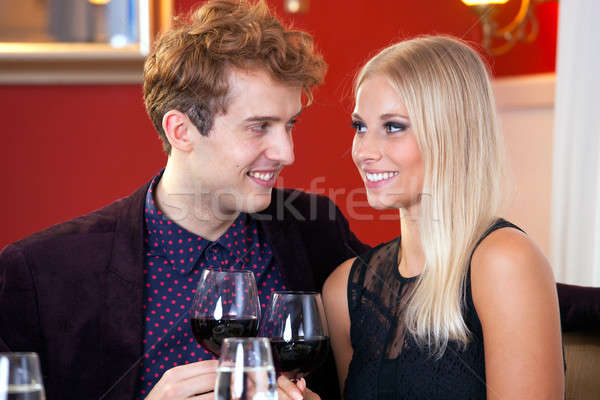 Happy couple celebrating with red wine Stock photo © belahoche