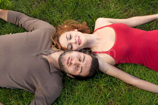 Stock photo: Young couple sleeping on green grass