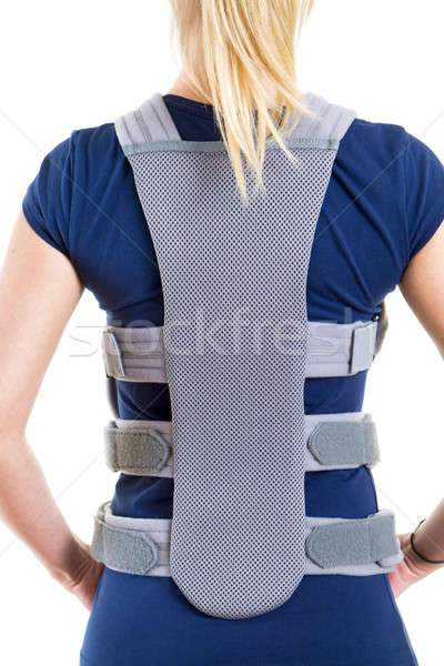 Woman Wearing Supportive Back Brace in Studio Stock photo © belahoche