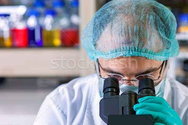 Male chemist working in a laboratory.  Stock photo © belahoche