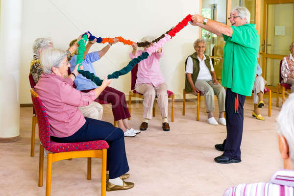 Arm Mobilität Klasse Senioren begeistert Therapeut Stock foto © belahoche