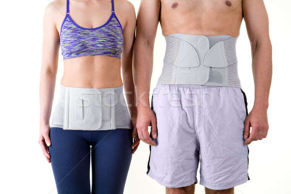 Stock photo: Athletic Man and Woman Wearing Back Support Braces