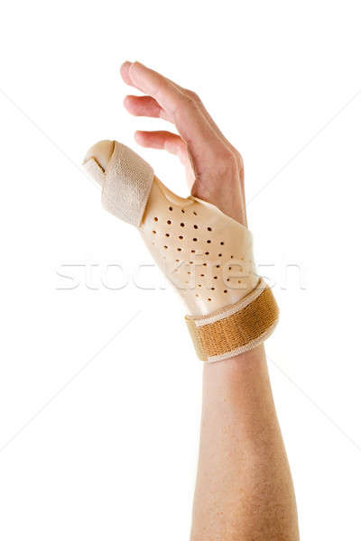 Hand Wearing Brace Over Thumb in White Studio Stock photo © belahoche