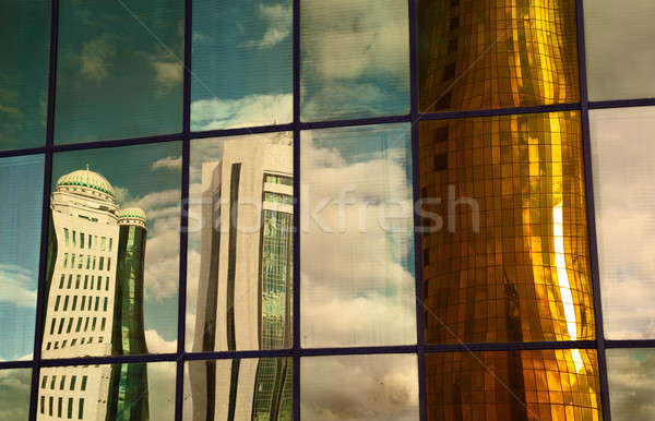 Tornyok eltorzult tükröződés felhőkarcolók modern város Stock fotó © Belyaevskiy