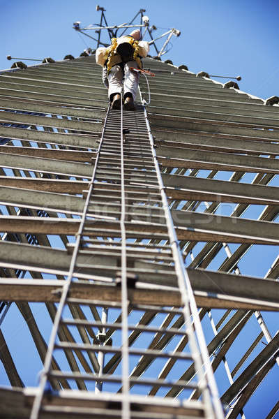 Climber ascending cell phone tower Stock photo © benkrut