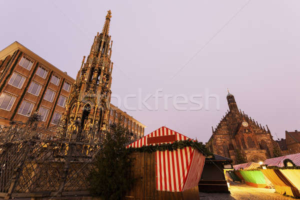 Christmas stalls on Hauptmarkt. Schöner Brunnen fountain and Ch Stock photo © benkrut