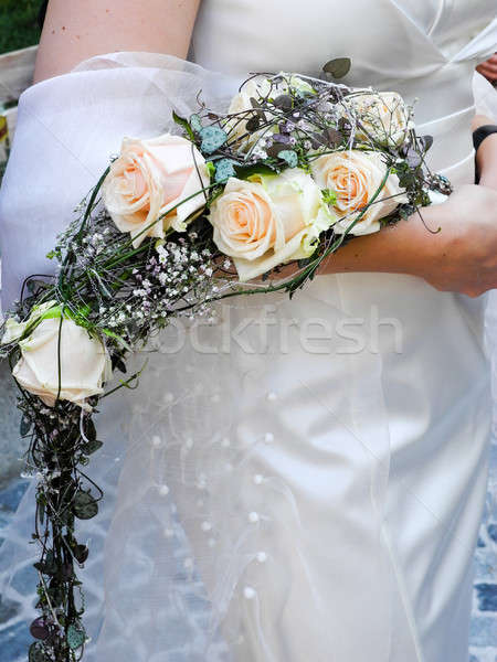 Stock photo: Bride holding her bridal flower bouquet in her hand