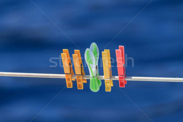 Clothespins on rope before blue background Stock photo © Bertl123