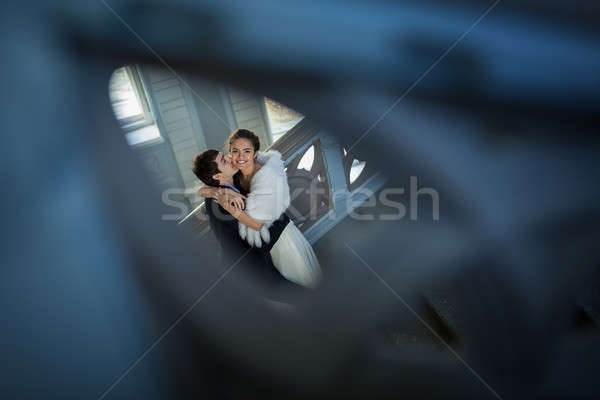 Kissing couple in love standing on a ladder Stock photo © bezikus