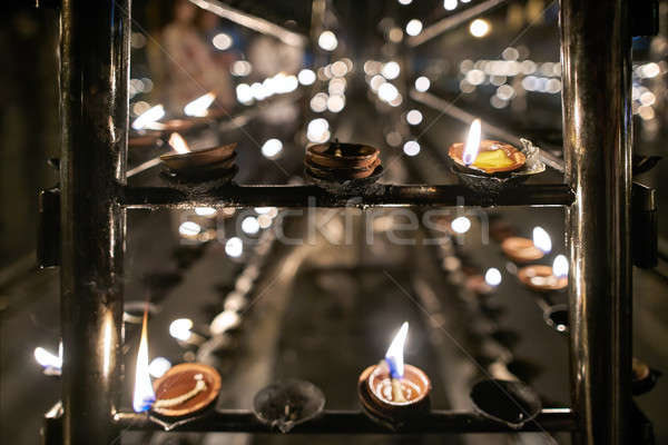 Oil candles inside buddhist temple Stock photo © bezikus