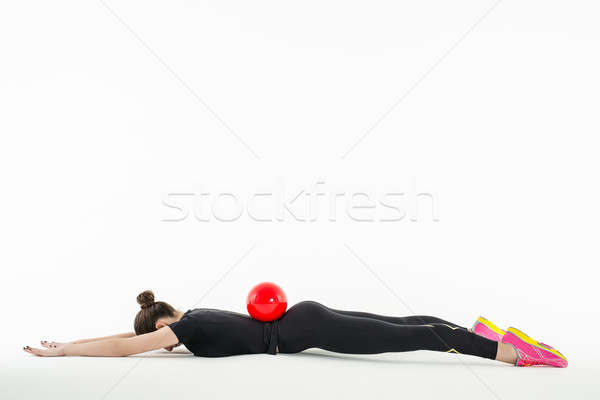 Rhythmic gymnast doing exercise with ball in studio Stock photo © bezikus