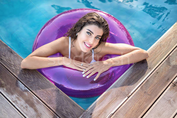 Model in rubber ring in swimming pool Stock photo © bezikus