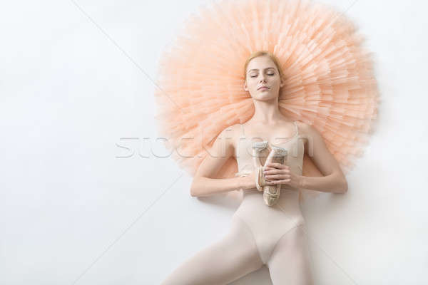 Blonde ballerina lies in studio Stock photo © bezikus