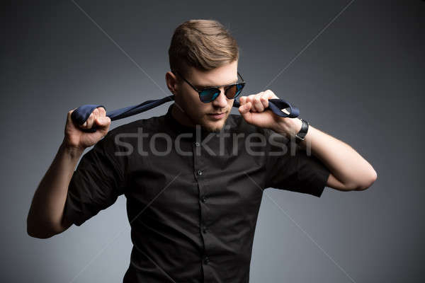 Stylish man in black shirt and mirrored sunglasses Stock photo © bezikus