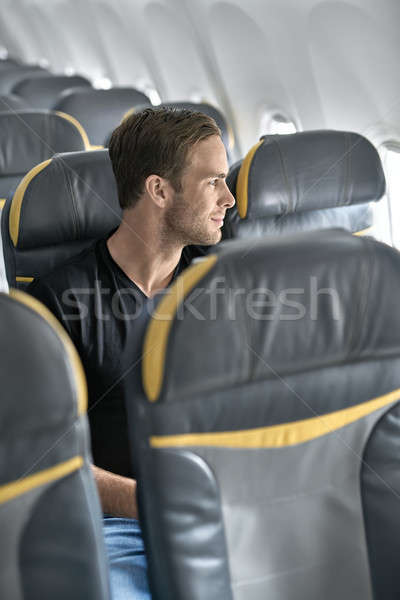 Yakışıklı adam uçak mutlu adam pencere Stok fotoğraf © bezikus