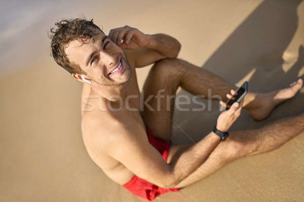 Tanned guy on beach Stock photo © bezikus