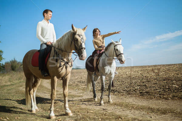 Young couple in love riding a horse Stock photo © bezikus
