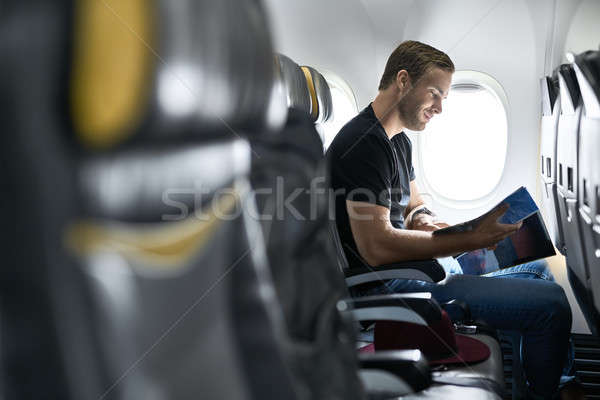 Jóképű fickó repülőgép örömteli férfi ablak Stock fotó © bezikus