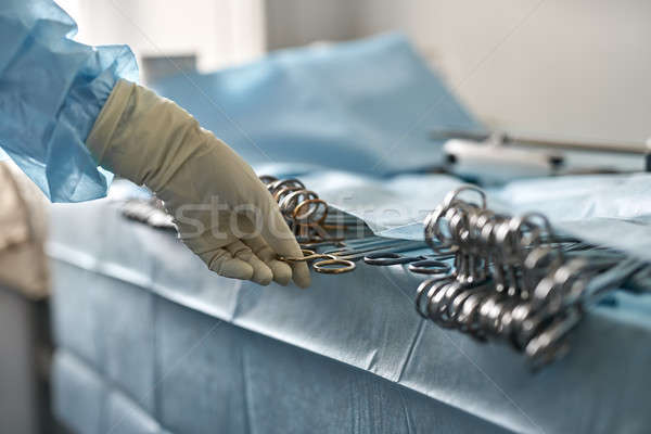 Doctor is taking forceps Stock photo © bezikus