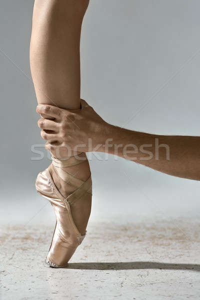 Guy holds ballerina's leg Stock photo © bezikus