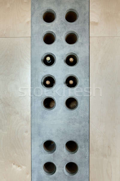Several bottles of wine in a special concrete hole Stock photo © bezikus