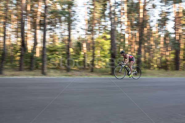 Menina bicicleta dinâmico estrada natureza Foto stock © bezikus