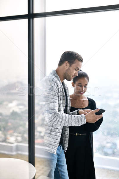 Casal alegre posando grande windows olhando Foto stock © bezikus