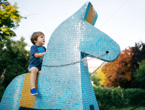 Weinig jongen paardrijden speelgoed paard keramische Stockfoto © bezikus