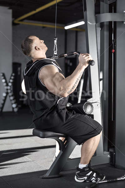 Strong man's workout in gym Stock photo © bezikus