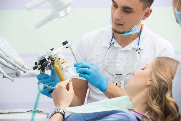 Stock photo: Modern dental clinic, young dentist working