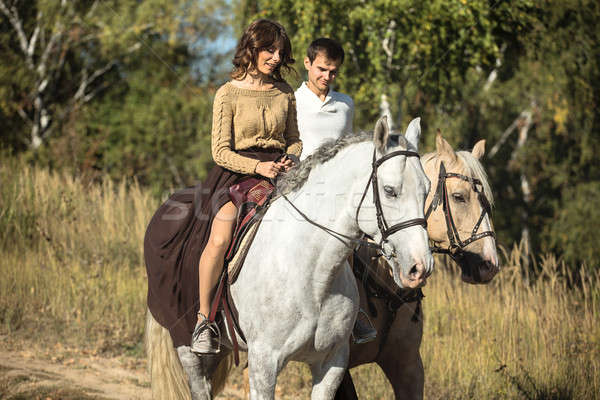 Young couple in love riding a horse Stock photo © bezikus