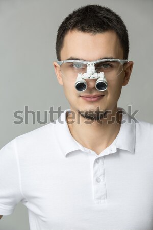 Doctor with binocular loupes Stock photo © bezikus