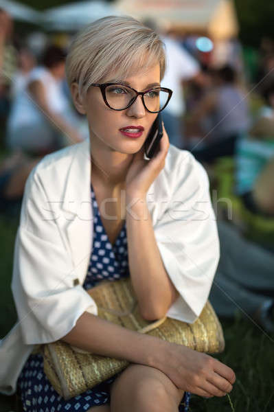 Blonde talks on cell outdoors Stock photo © bezikus