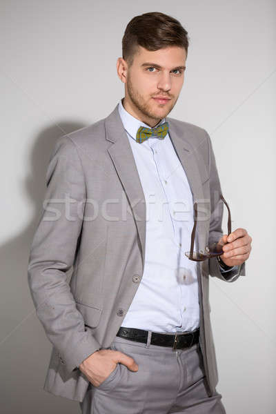 Attractive man in a suit and tie butterfly dress stylish sunglas Stock photo © bezikus