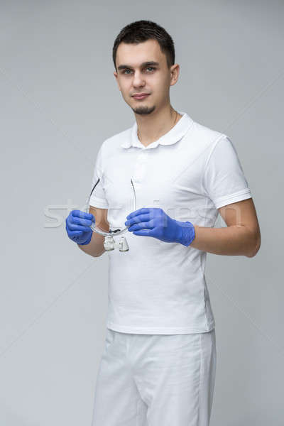 Dentist alb uniforma parul inchis la culoare medic în picioare Imagine de stoc © bezikus