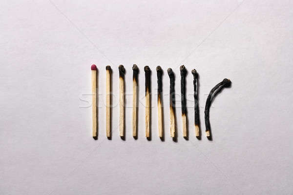 Burnt matchsticks on background in studio Stock photo © bezikus