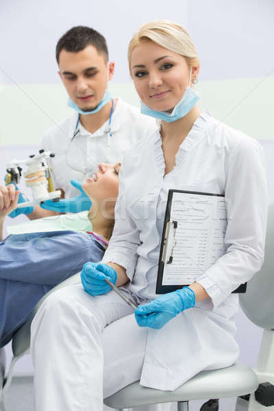 Stock photo: Modern dental clinic, young dentist working