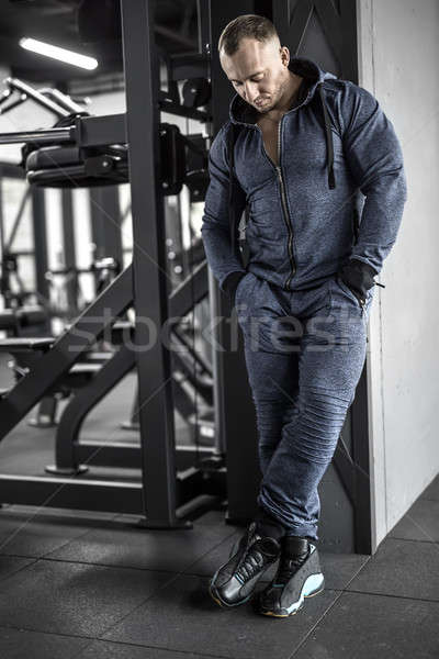 Muscular man posing in gym Stock photo © bezikus