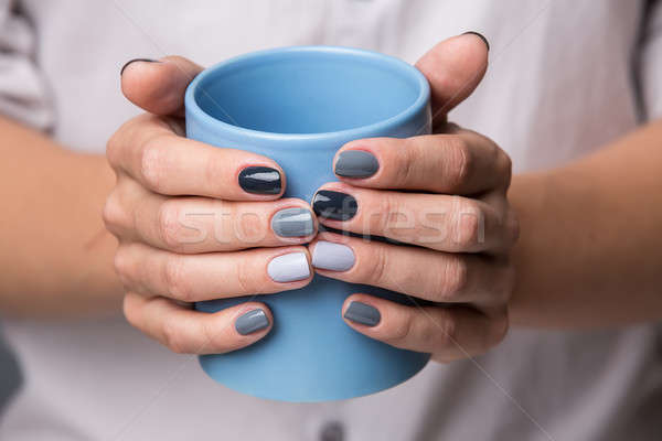 Female hands with blue cup Stock photo © bezikus