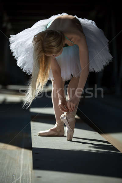 Stock photo: Dancer tying pointe shoes