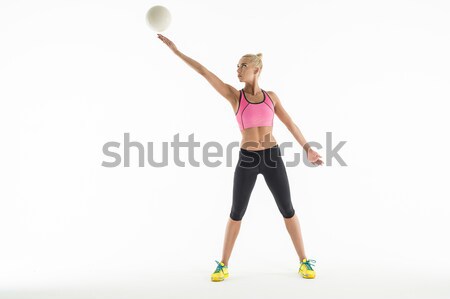 Rhythmic gymnast doing exercise with ball in studio. Stock photo © bezikus