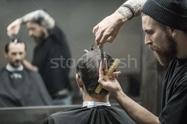Doing haircut in barbershop Stock photo © bezikus