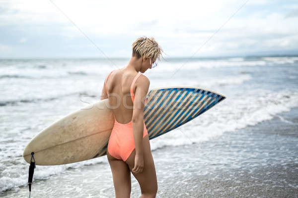 Woman with surfboard on beach Stock photo © bezikus